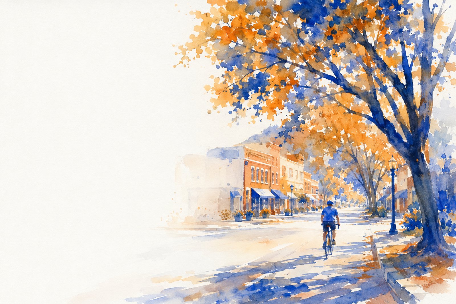 A cyclist riding down an oak-lined street in downtown Jacksonville, Oregon.